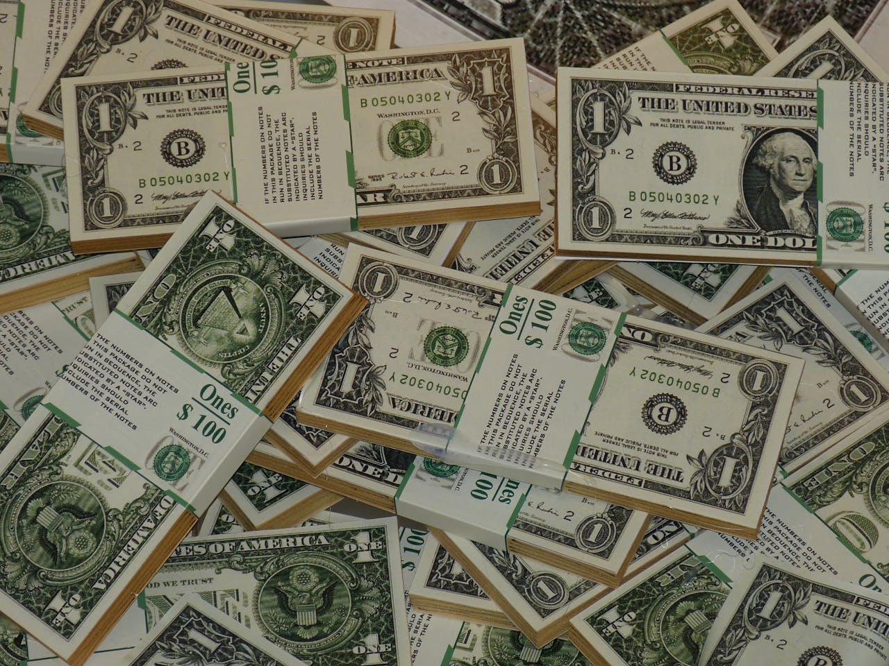 Home Numerous bundles of US one dollar bills symbolizing wealth, finance, and savings.