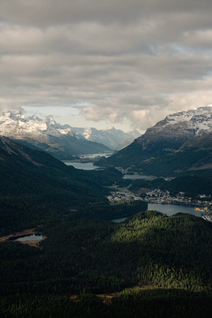 Mastering the First Impression: Your intriguing post title goes here Breathtaking aerial view of Engadin Valley in the Swiss Alps, showcasing scenic mountains and lush forests.